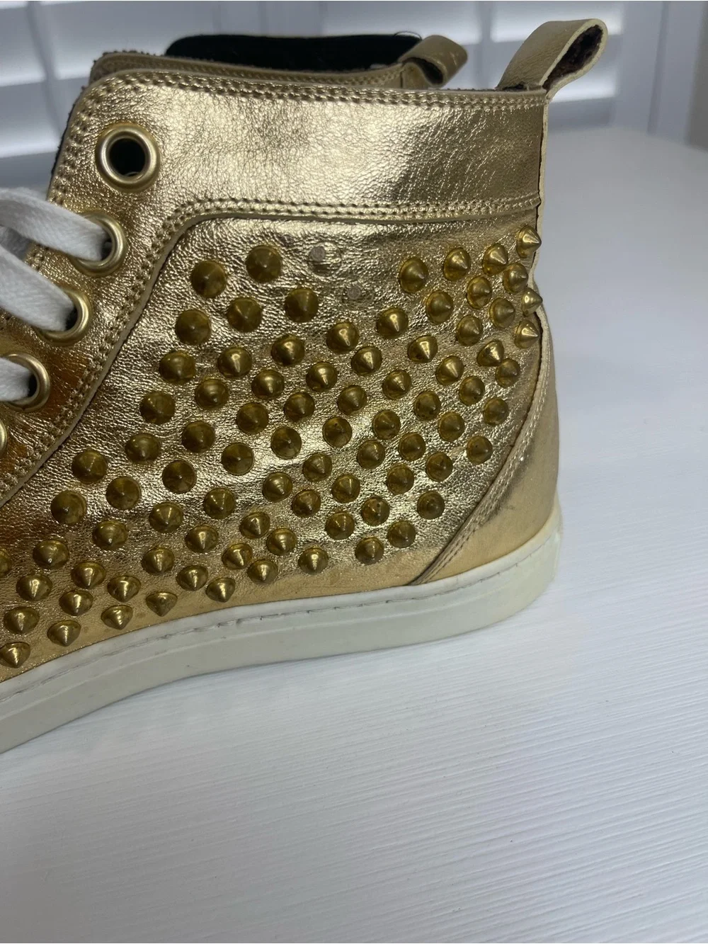 Metallic Gold High-Top Sneakers with Stud Details by Rodney P. Hunt